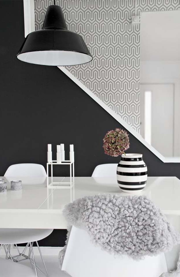 Add printed accents to break up the dark walls. Add white and grey accessories to complete your monochromatic home.