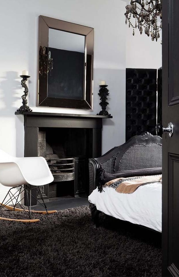 We are obsessing over this room. The chandelier, and black wicker bed, and Eames rocker complement each other nicely.