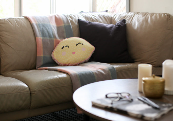 Roadside sofa, thrift store blanket, Kmart lemon cushion