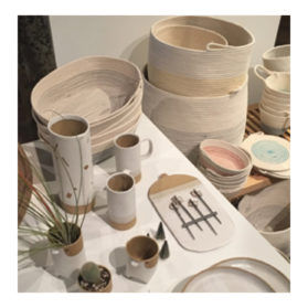 table of ceramic mugs, plants and woven baskets