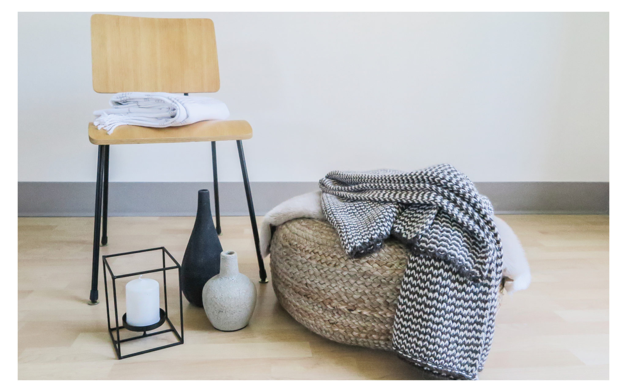 hygge details with rattan pouff and layered throw blankets