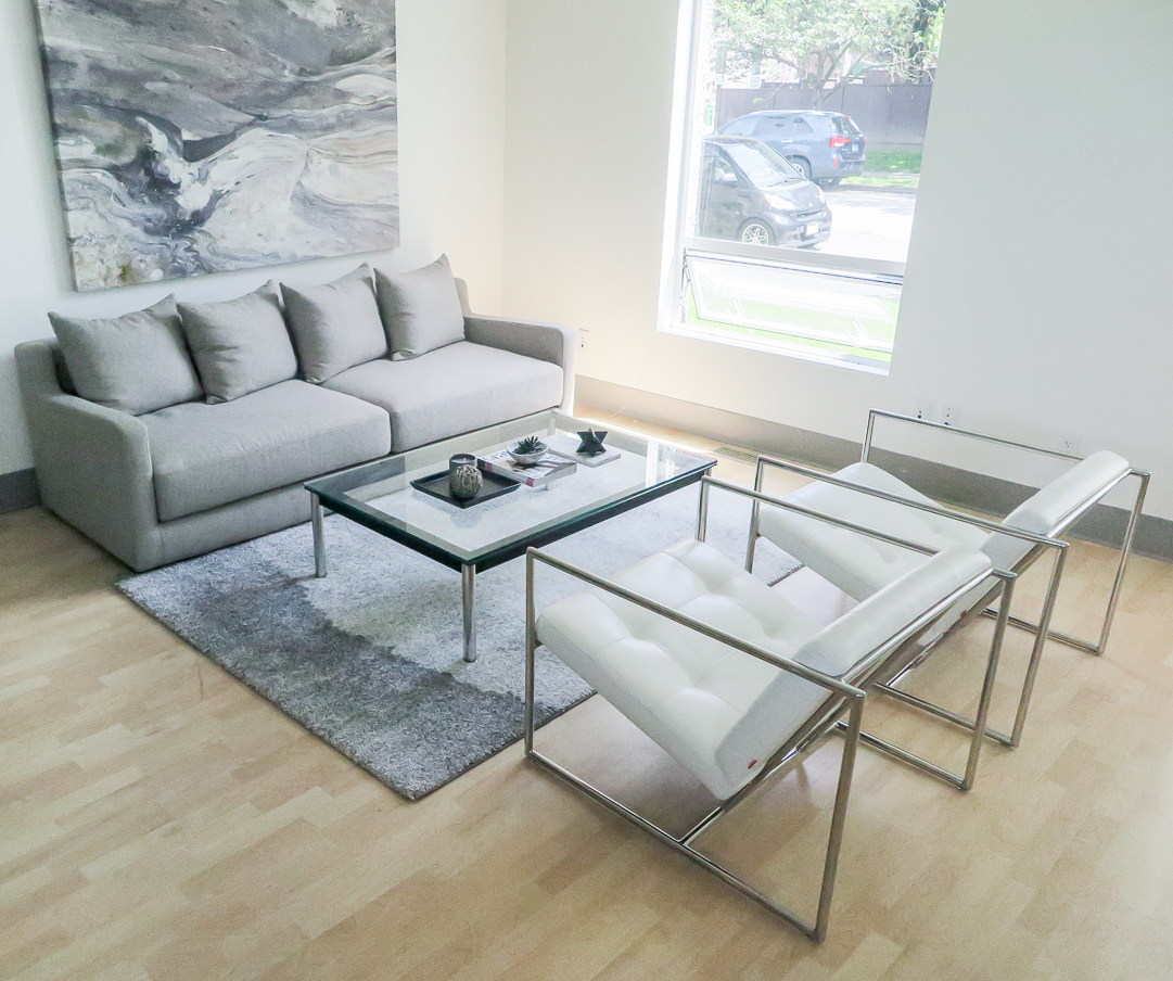 grey sofa with 2 white armchairs in monochromatic livingroom