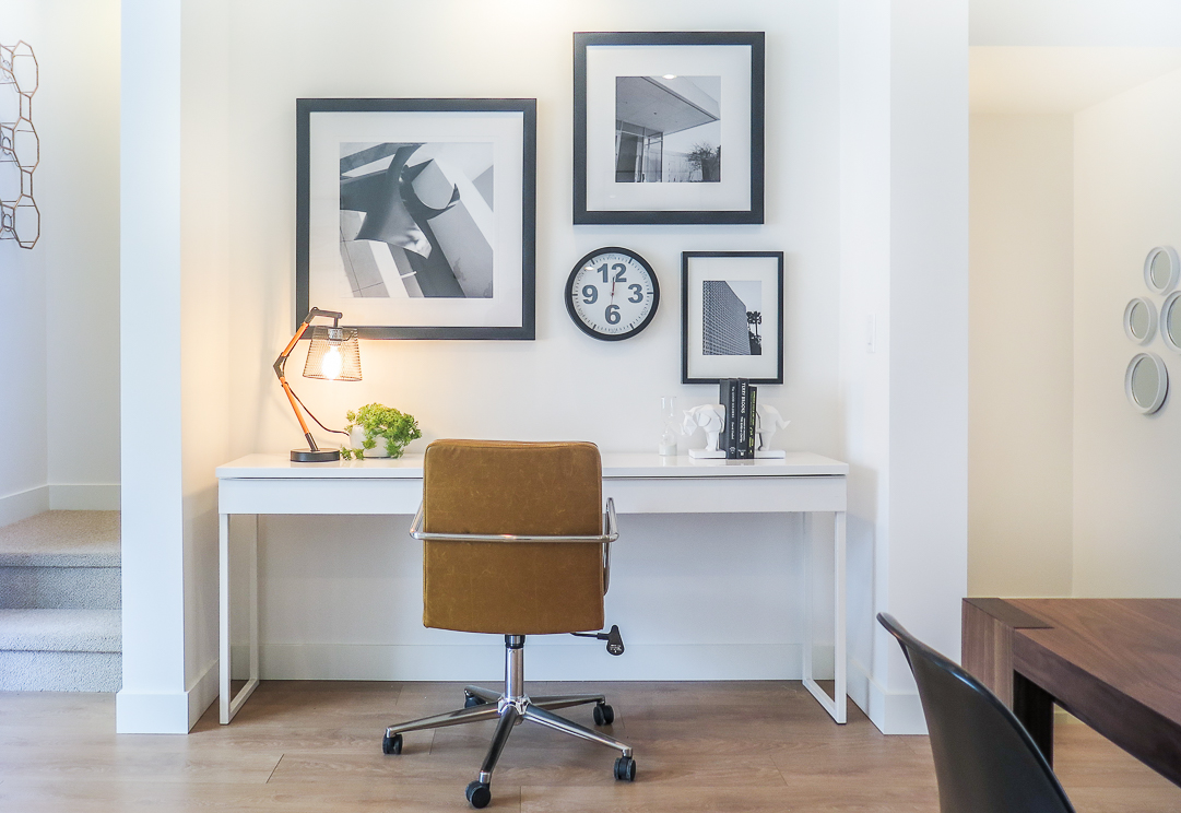 home office with gallery wall and caramel leather office chair
