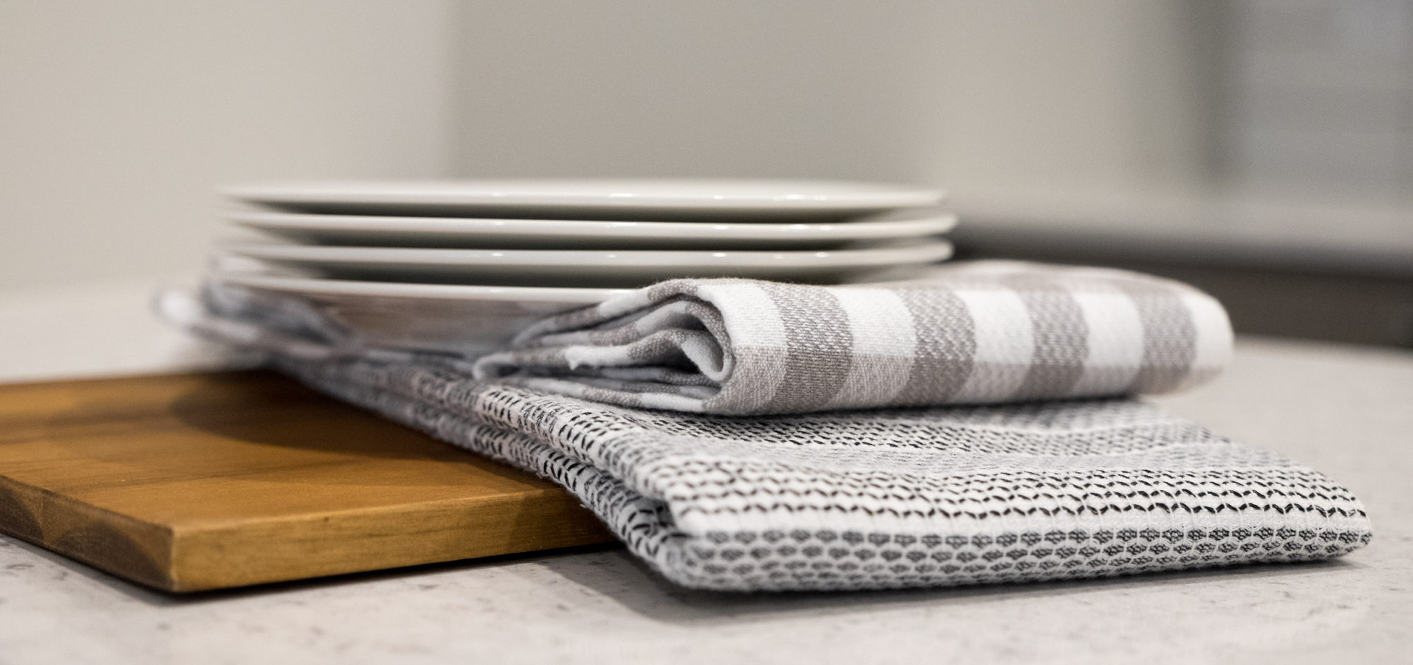 close up of plates and dish towels in grey stripes